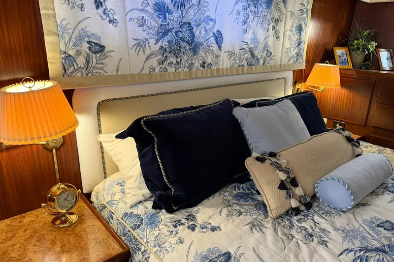 Slide: The Image of Luxurious bedroom interior of 1986 Hatteras 63 Cockpit Motor Yacht with elegant floral decor. - 47