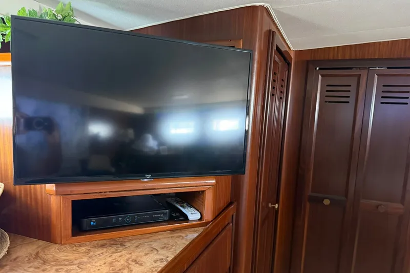 Slide: The Image of Flat-screen TV and entertainment system in 1986 Hatteras 63 Cockpit Motor Yacht interior. - 48