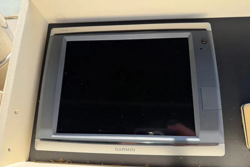 Slide: The Image of Garmin GPS device on 1986 Hatteras 63 Cockpit Motor Yacht dashboard. - 65