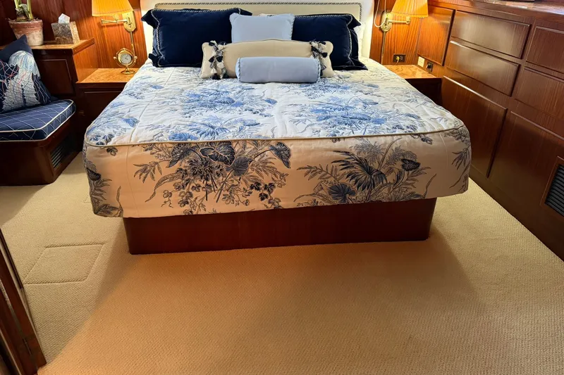 Slide: The Image of Luxurious bedroom interior of 1986 Hatteras 63 Cockpit Motor Yacht with floral bedding. - 44