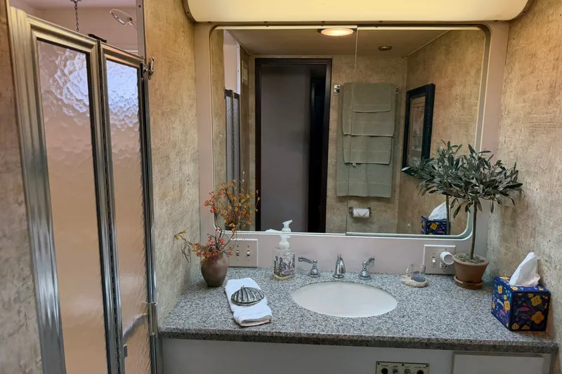 Slide: The Image of Bathroom interior of 1986 Hatteras 63 Cockpit Motor Yacht with granite countertop and plants. - 42