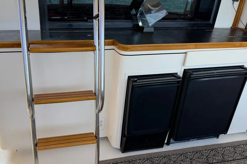 Slide: The Image of Interior of 1986 Hatteras 63 Cockpit Motor Yacht with ladder and storage compartments. - 24