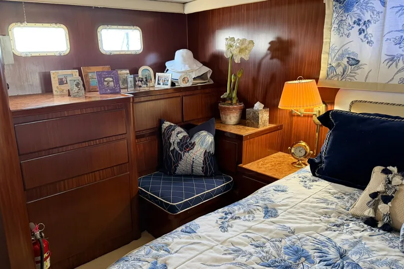 Slide: The Image of Cozy bedroom in 1986 Hatteras 63 Cockpit Motor Yacht with floral decor and wooden furnishings. - 46
