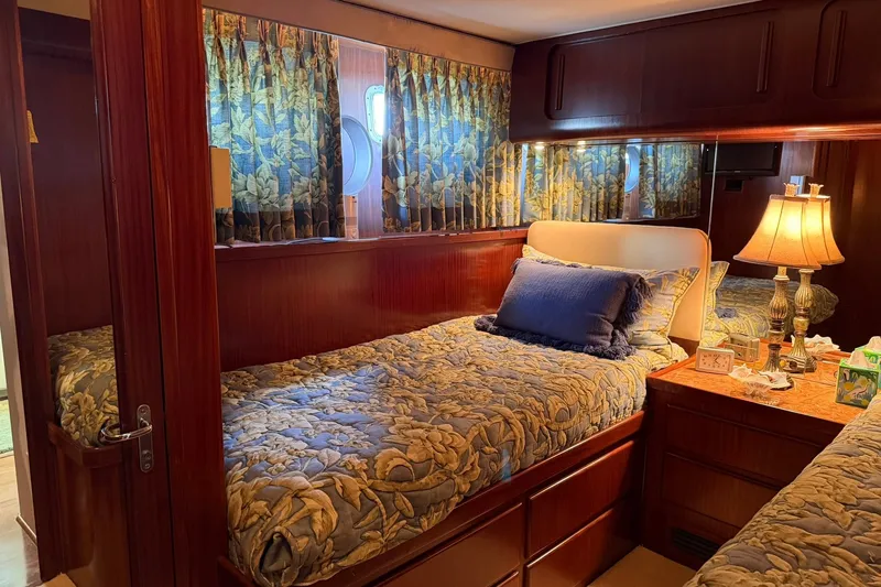 Slide: The Image of Luxurious cabin interior of 1986 Hatteras 63 Cockpit Motor Yacht with elegant bedding and decor. - 39