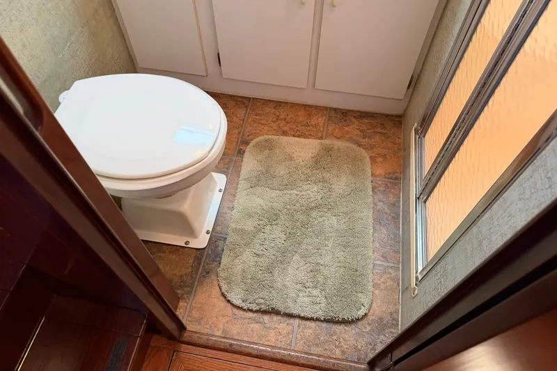 Slide: The Image of Bathroom interior of 1986 Hatteras 63 Cockpit Motor Yacht with toilet and shower. - 34