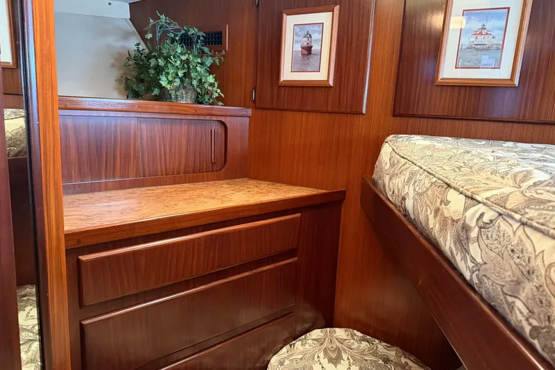Slide: The Image of Interior of 1986 Hatteras 63 Cockpit Motor Yacht with wood paneling and decorative elements. - 35