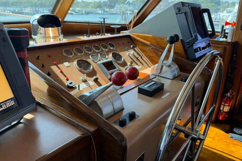 Slide: The Image of Helm of 1986 Hatteras 63 Cockpit Motor Yacht with classic controls and navigation equipment. - 17