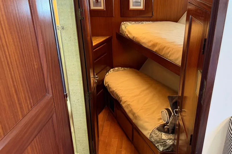 Slide: The Image of Interior of 1986 Hatteras 63 Cockpit Motor Yacht with wooden bunk beds. - 32