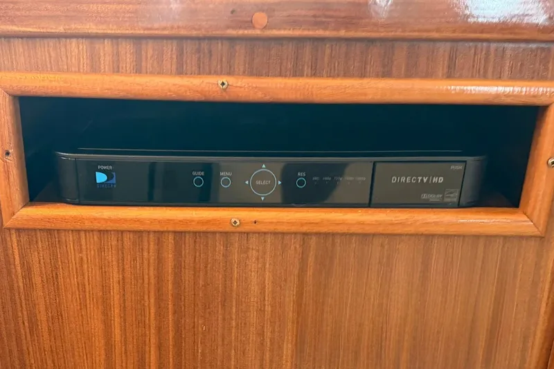 Slide: The Image of DirectTV HD receiver in wooden cabinet on 1986 Hatteras 63 Cockpit Motor Yacht. - 15
