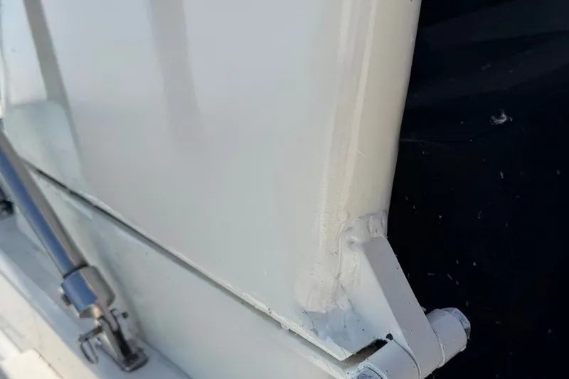 Slide: The Image of Close-up of 1986 Hatteras 63 Cockpit Motor Yacht hinge and hydraulic component. - 68