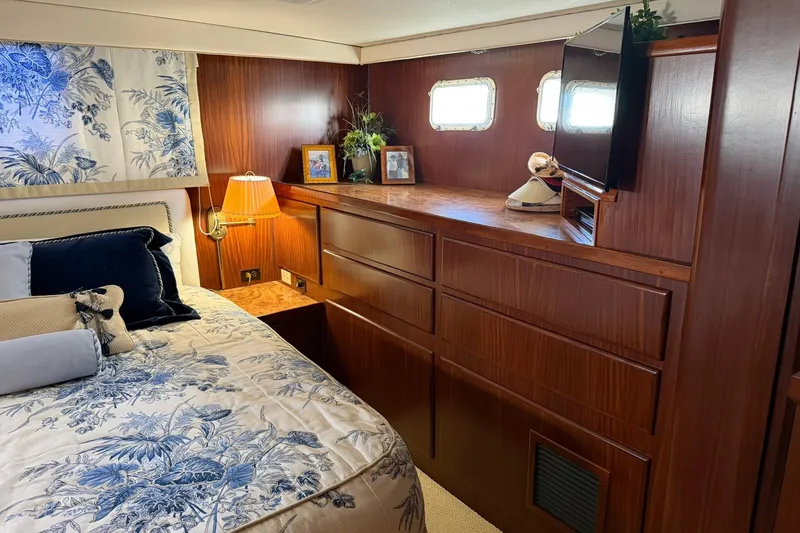 Slide: The Image of Luxurious cabin interior of 1986 Hatteras 63 Cockpit Motor Yacht with elegant wood finish. - 45