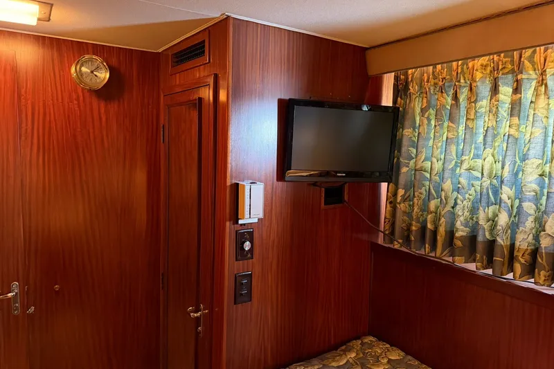 Slide: The Image of Interior of 1986 Hatteras 63 Cockpit Motor Yacht with wood paneling and floral curtains. - 41