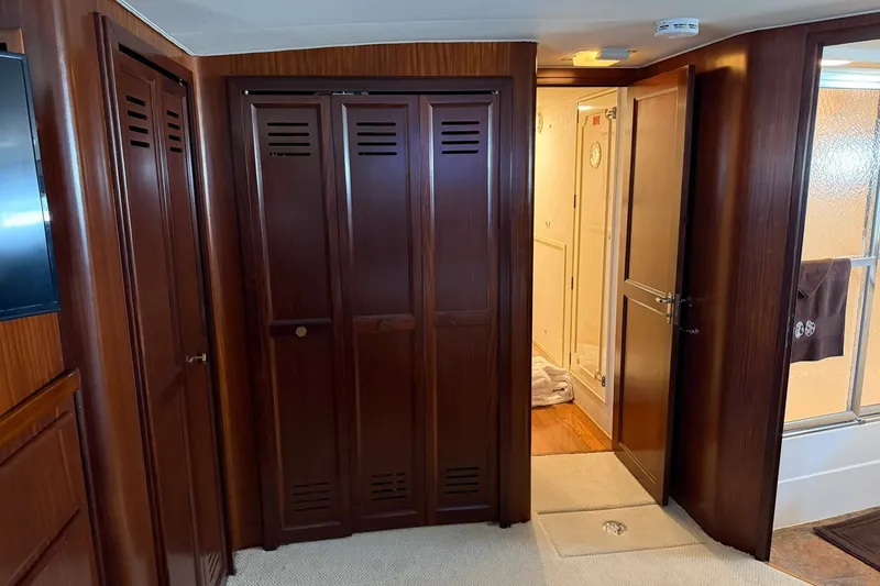 Slide: The Image of Interior of 1986 Hatteras 63 Cockpit Motor Yacht with wooden cabinetry and open door. - 50