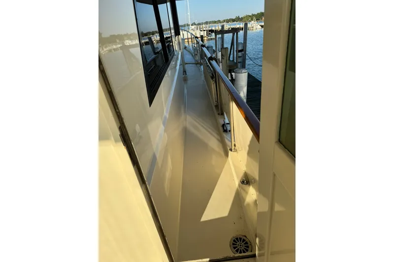 Slide: The Image of Side deck view of 1986 Hatteras 63 Cockpit Motor Yacht at dock. - 71