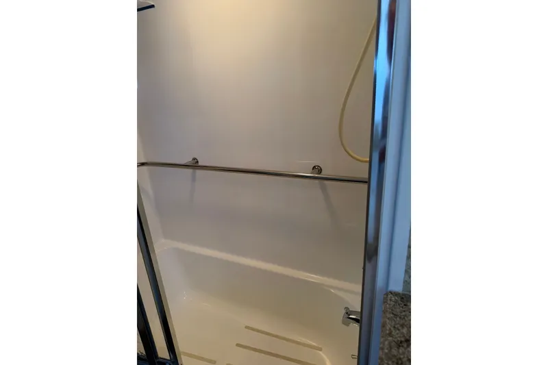 Slide: The Image of Shower area in 1986 Hatteras 63 Cockpit Motor Yacht, featuring sleek design and chrome fixtures. - 52