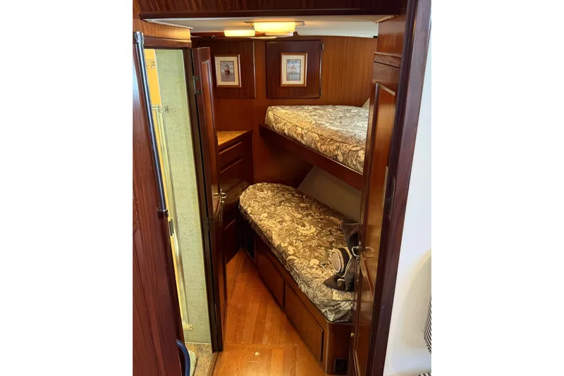 Slide: The Image of Interior of 1986 Hatteras 63 Cockpit Motor Yacht with wooden bunk beds. - 33