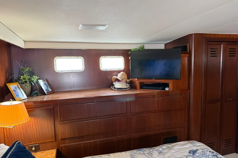 Slide: The Image of Interior of 1986 Hatteras 63 Cockpit Motor Yacht with wood paneling and decor. - 49