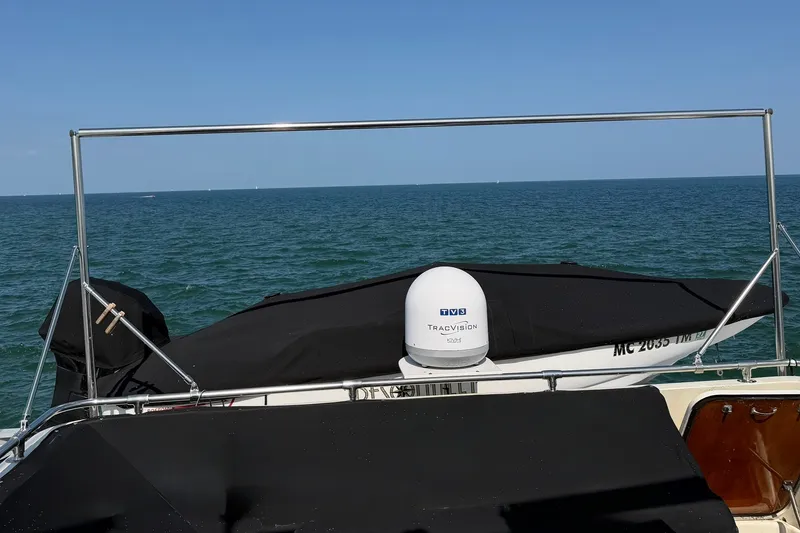 Slide: The Image of 1986 Hatteras 63 Cockpit Motor Yacht with TracVision, ocean view in background. - 55