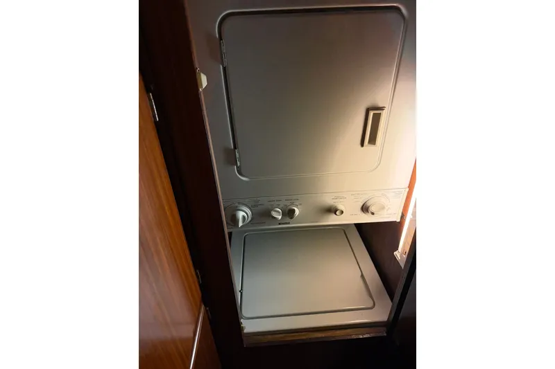 Slide: The Image of Stacked washer and dryer unit inside 1986 Hatteras 63 Cockpit Motor Yacht. - 37