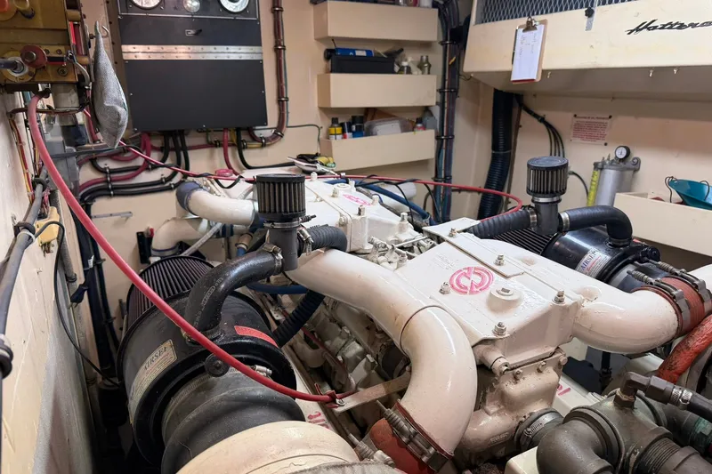 Slide: The Image of Engine room of a 1986 Hatteras 63 Cockpit Motor Yacht, showcasing mechanical components. - 78