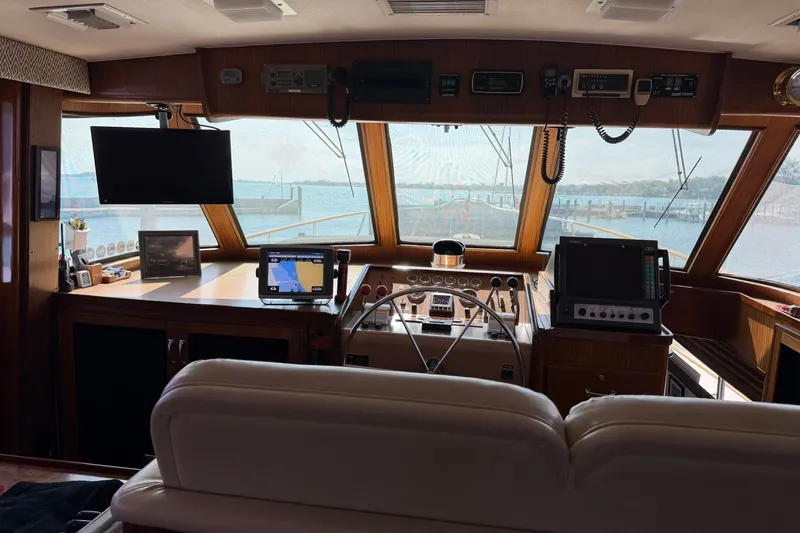 Slide: The Image of Interior view of 1986 Hatteras 63 Cockpit Motor Yacht helm with navigation equipment. - 16