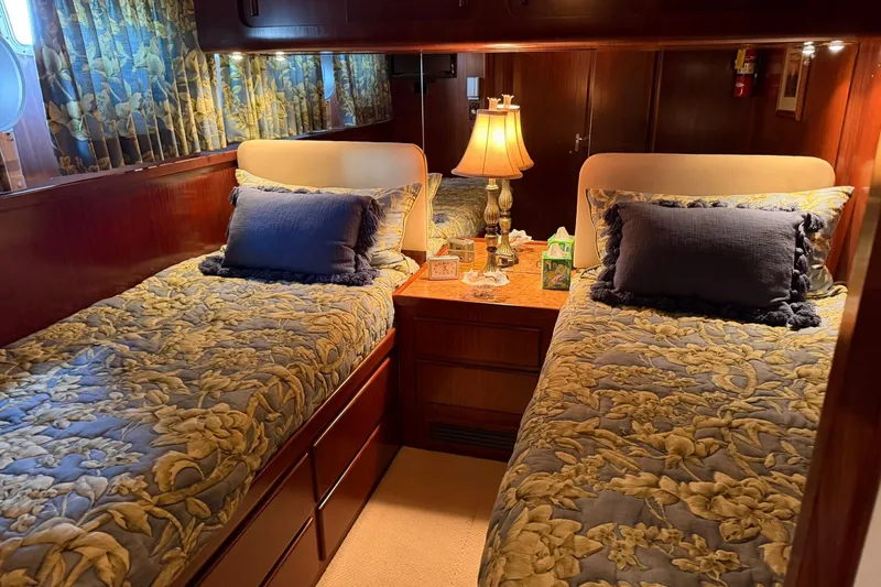 Slide: The Image of Twin beds in a cozy cabin of a 1986 Hatteras 63 Cockpit Motor Yacht. - 40