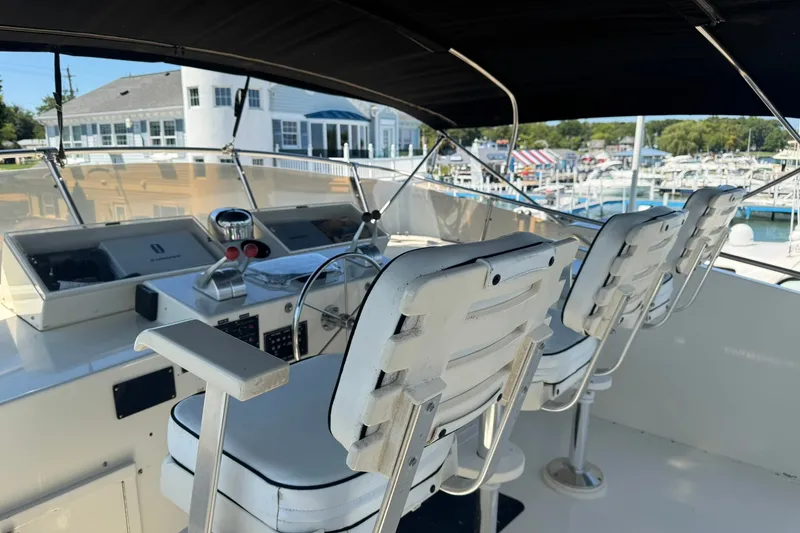 Slide: The Image of Cockpit of 1986 Hatteras 63 Cockpit Motor Yacht with helm chairs and controls. - 61