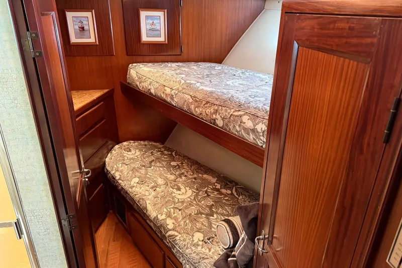 Slide: The Image of Bunk beds in 1986 Hatteras 63 Cockpit Motor Yacht cabin with wood paneling. - 31