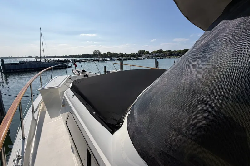 Slide: The Image of 1986 Hatteras 63 Cockpit Motor Yacht docked at a marina, sunny day. - 72