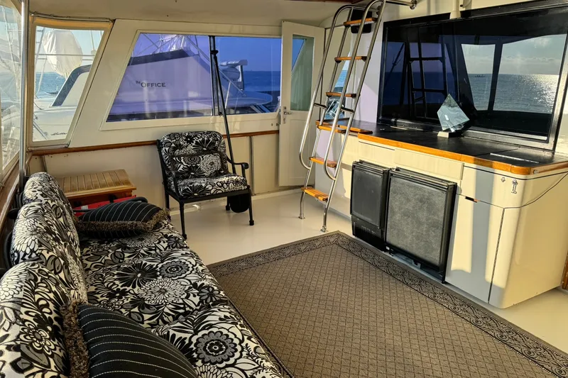 Slide: The Image of Interior of 1986 Hatteras 63 Cockpit Motor Yacht with patterned seating and ocean view. - 53