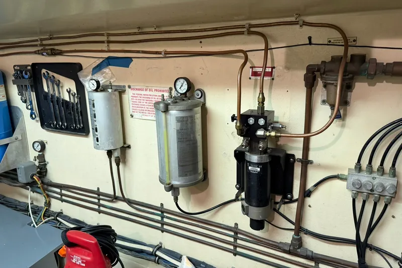 Slide: The Image of Engine room of 1986 Hatteras 63 Cockpit Motor Yacht with tools and gauges. - 79