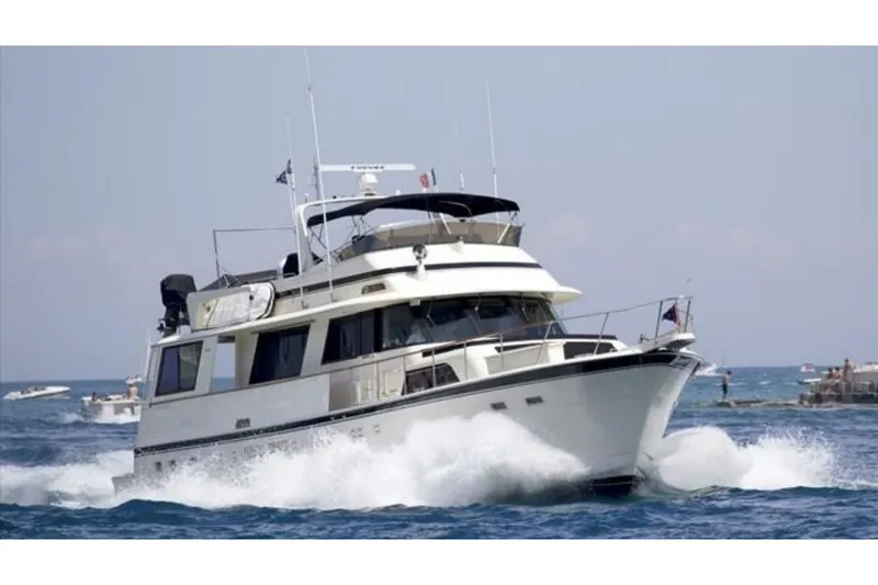 The Image of 1986 Hatteras 63 Cockpit Motor Yacht cruising on open water. - 0