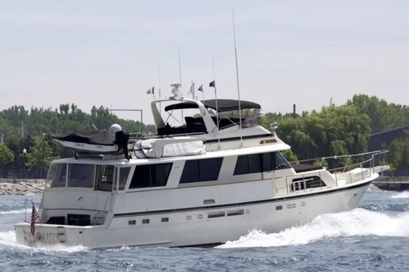 Slide: The Image of 1986 Hatteras 63 Cockpit Motor Yacht cruising on a sunny day. - 1