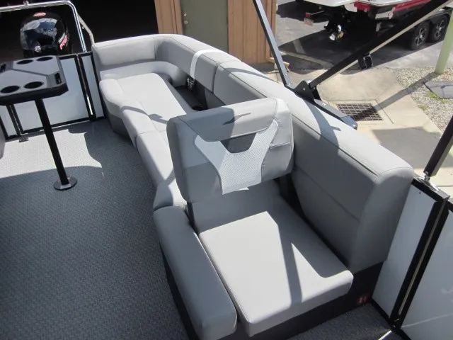 Slide: The Image of The image shows a modern, gray seating area on a boat with a table and cushioned seats. - 17