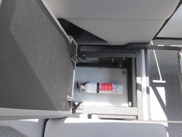 Slide: The Image of An open storage compartment in the boat reveals a fire extinguisher. The upholstery is gray. - 20