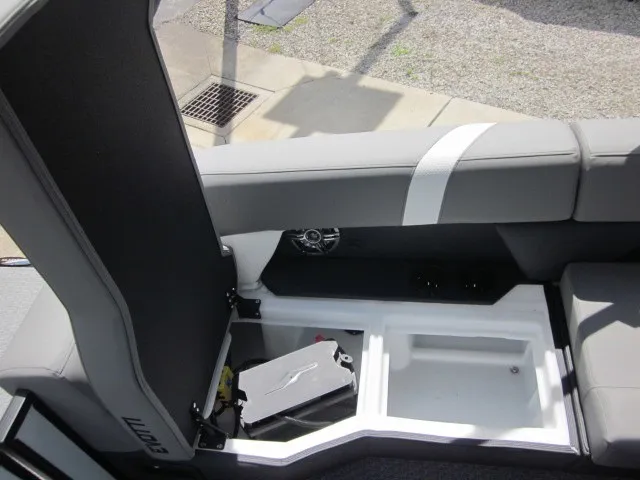 Slide: The Image of The image shows a boat seating area with gray upholstery and an open storage compartment. - 23