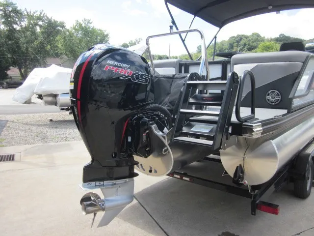 Slide: The Image of An Evotti 521 QL boat with a Mercury Pro XS outboard motor, parked on a trailer. - 30