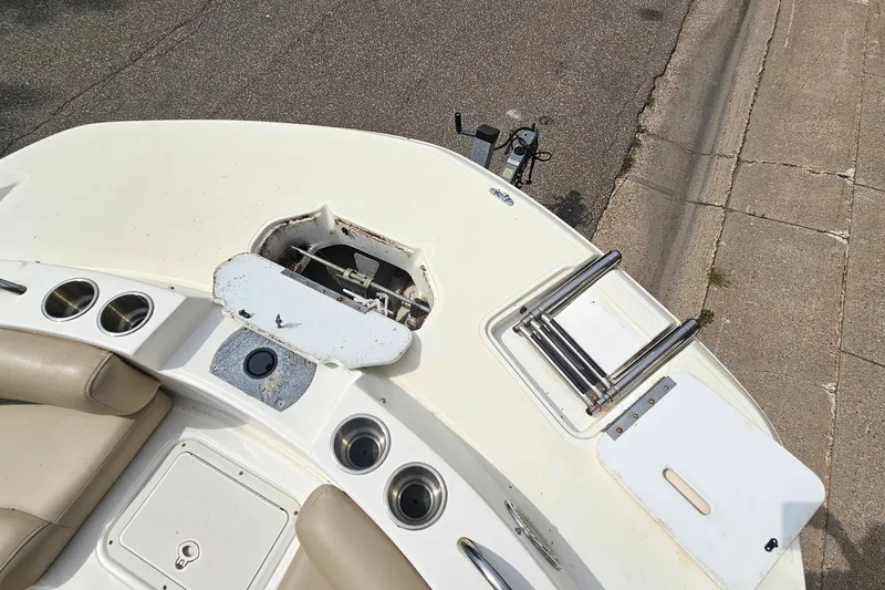 Slide: The Image of 2017 Hurricane SunDeck Sport 188 OB boat interior with cup holders and ladder. - 16