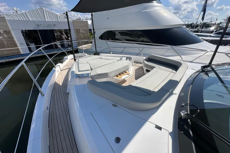 Slide: The Image of Luxurious 2026 Fairline Squadron 58 yacht with spacious deck seating under a sunny sky. - 64