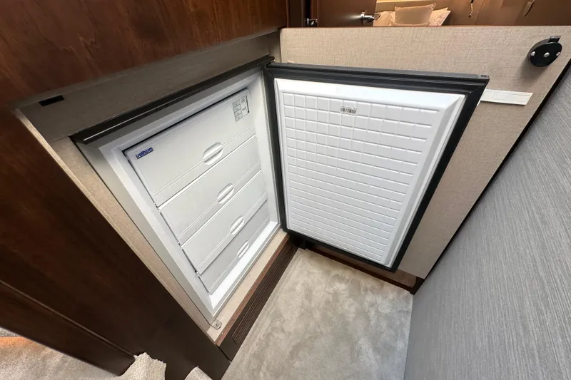 Slide: The Image of Built-in freezer on Fairline Squadron 58 yacht, 2026 model, with multiple storage drawers. - 44