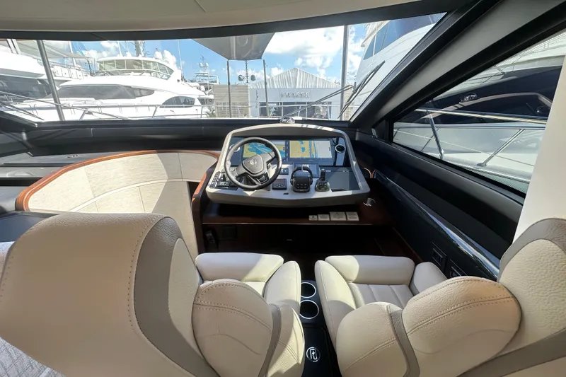 Slide: The Image of Interior cockpit of 2026 Fairline Squadron 58 yacht, featuring modern navigation equipment. - 23