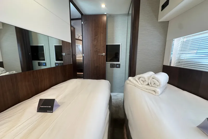Slide: The Image of Luxurious cabin interior of 2026 Fairline Squadron 58 yacht with twin beds and modern decor. - 28
