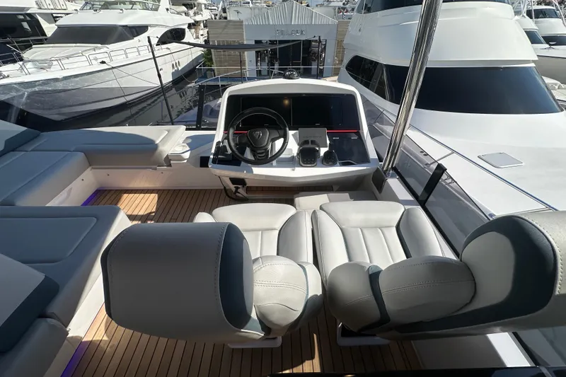 Slide: The Image of Luxurious 2026 Fairline Squadron 58 yacht cockpit with modern seating and steering wheel. - 55