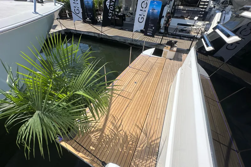 Slide: The Image of Luxury Fairline Squadron 58 yacht deck, 2026 model, with elegant wooden finish and dockside view. - 60