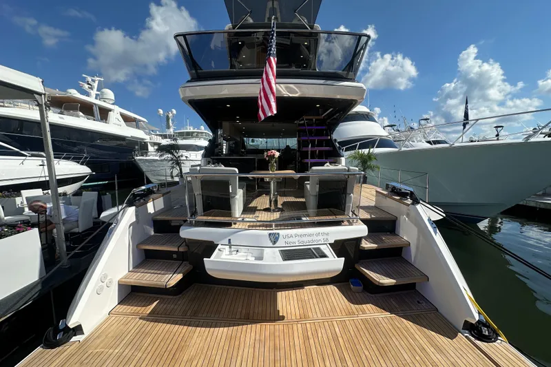 Slide: The Image of Luxury Fairline Squadron 58 yacht, 2026 model, docked at marina under clear blue sky. - 10