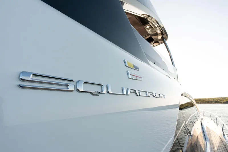 Slide: The Image of 2026 Fairline Squadron 58 yacht, sleek design, close-up view, docked on calm water. - 8