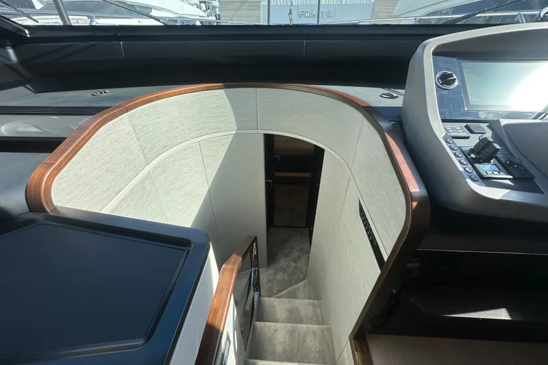 Slide: The Image of Interior staircase of 2026 Fairline Squadron 58 yacht, featuring modern design and controls. - 25