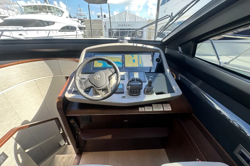 Slide: The Image of Helm of 2026 Fairline Squadron 58 yacht with navigation controls and display. - 24
