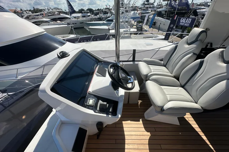 Slide: The Image of Helm of 2026 Fairline Squadron 58 yacht with modern controls and seating. - 56