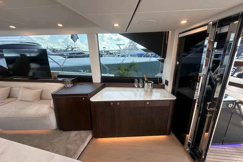 Slide: The Image of Luxurious interior of 2026 Fairline Squadron 58 yacht with elegant seating and bar area. - 16